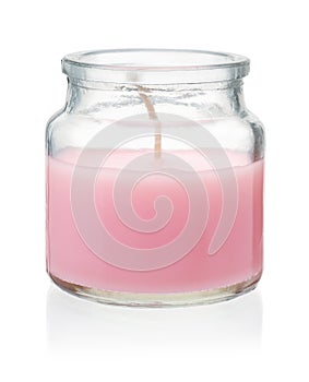 Pink homemade candle in glass jar