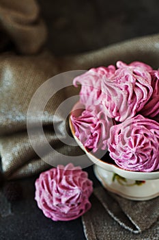 Pink homemade zephyr or marshmallow on dark background