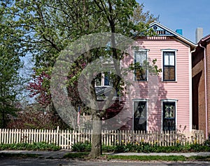 Pink House with Blue Trim & Cream Picket Fence