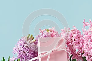 Pink hyacinth spring flowers with pink gift box on blue banner