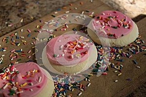 Pink Iced Cookies on a Wooden background