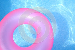 Pink inner tube on blue water
