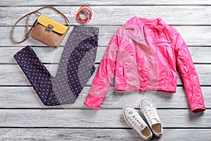 Pink jacket with dotted trousers.