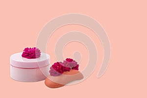 Pink jar mockup for cream or mask, soap and a small pink-Red roses on orange background. Isolated,