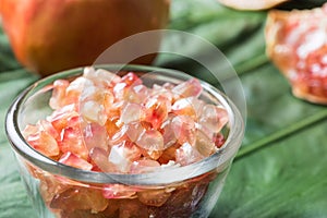 Pink juice pomegranate on leaf background