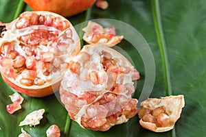 Pink juice pomegranate on leaf background