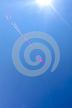 Pink kite flying with blue sky in Germany