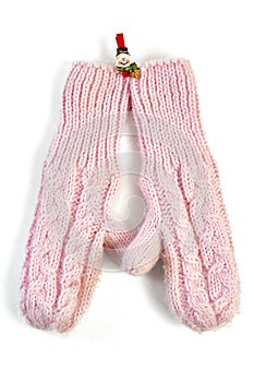 Pink knitted mittens on clothespin-snowman isolated
