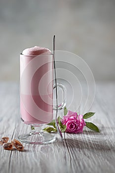 Pink Latte Tea. Pink hibiscus latte. Fashionable romantic drink. Dry flowers of roses. Pink background