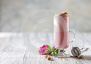 Pink Latte Tea. Pink hibiscus latte. Fashionable romantic drink. Dry flowers of roses. Pink background