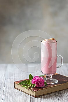 Pink Latte Tea. Pink hibiscus latte. Fashionable romantic drink. Dry flowers of roses. Pink background