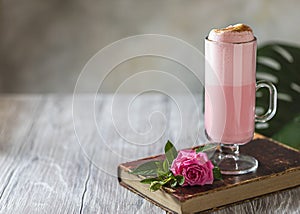 Pink Latte Tea. Pink hibiscus latte. Fashionable romantic drink. Dry flowers of roses. Pink background