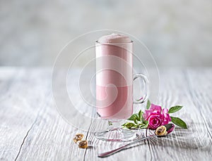 Pink Latte Tea. Pink hibiscus latte. Fashionable romantic drink. Dry flowers of roses. Pink background