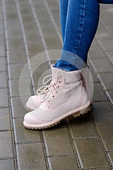 Pink leather boots on woman`s legs