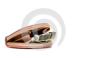 Pink leather wallet close-up with rolled-up dollars, on an isolated white background. The concept of financial assets