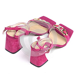 Pink leather women's sandals with a gold chain and a beige weap with a thick heel with a blunt toe on a white