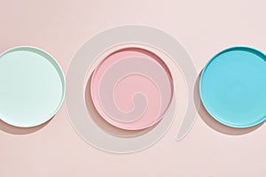 Pink, light blue, blue, pastel color plates set isolated on pink