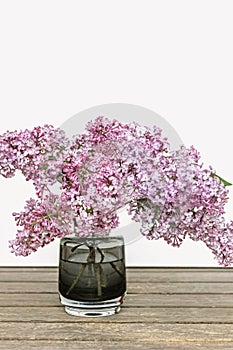 Pink lilac flower bouquet in glass vase