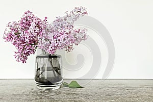 Pink lilac flower bouquet in glass vase