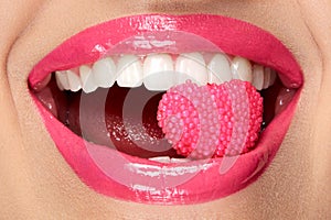 Pink Lips. Woman With Candy In Mouth.