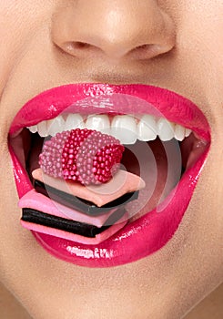 Pink Lips. Woman With Candy In Mouth.