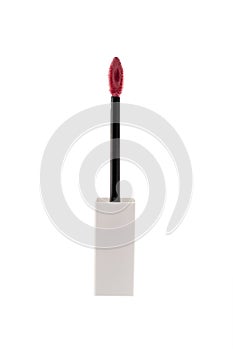 Pink liquid lipstick applicator brush on brright background photo