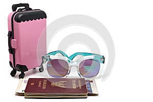 Pink luggage, Thai passport with banknotes and fashion sunglasses