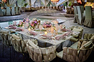 Pink luxury table flower decoration with glass globets wedding event party at night, coctel table with candles