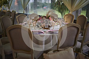 Pink luxury table flower decoration with glass globets wedding event party at night, coctel table with candles photo