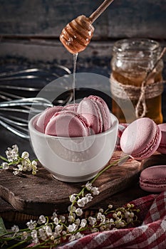 Pink macaroni with honey in a white plate