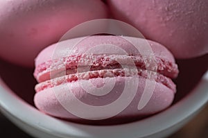 Pink macaroni with honey in a white plate