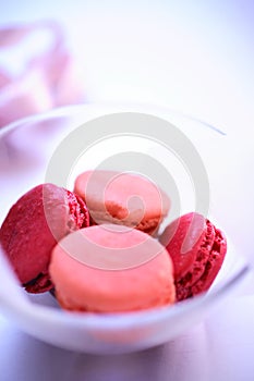 Pink macaroons in glass bowl