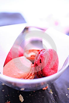 Pink macaroons in glass bowl