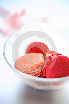 Pink macaroons in glass bowl