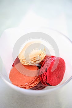 Pink macaroons in glass bowl