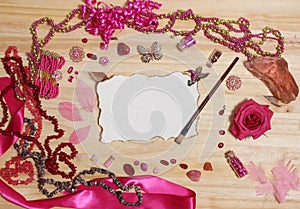 Pink and Magenta Jewelry With Flower and Blank Paper With Burned Edges