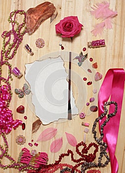 Pink and Magenta Jewelry With Flower and Blank Paper With Burned Edges