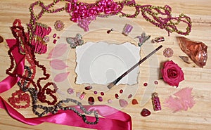 Pink and Magenta Jewelry With Flower and Blank Paper With Burned Edges