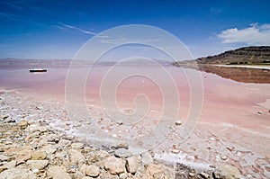 Pink Maharloo Lake with swan pedal boats in Shiraz, Iran