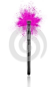 Pink make up brush with powder splash close-up