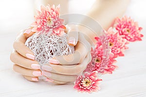 Pink manicure with chrysanthemum flowers. spa