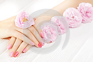 Pink manicure with tea rose flowers. spa