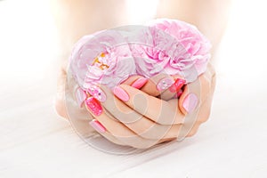 Pink manicure with tea rose flowers. spa
