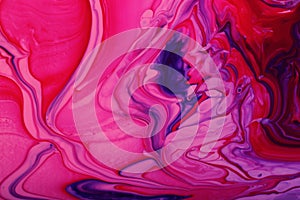 Pink marble background with abstract stains.Mixed nail polishes-pink and blue.Modern backdrop.Fluid art technique.Good for placing