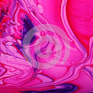 Pink marble background with abstract stains.Mixed nail polishes-pink and blue.Modern backdrop.Fluid art technique.Good for placing