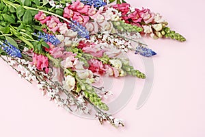 Pink matthiola and blue muscari flowers in one bouquet