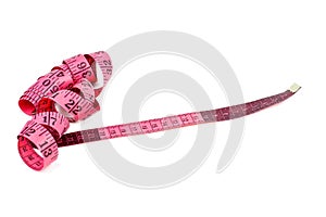 Pink measuring tape isolaten on a white