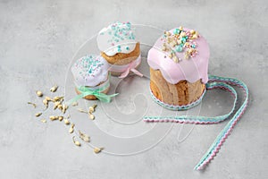 Pink and mint easter cakes decorated by ribbons and modern ingredients of dry flowers