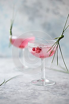 Pink mocktail close up. Beverage with rose and prosecco wine in drinkware. Exotic French Martini cocktail portion with crushed ice
