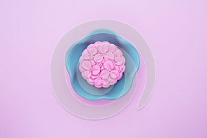 Pink mooncake, blue teapot, cup of green tea on a pink background. Chinese mid-autumn festival food